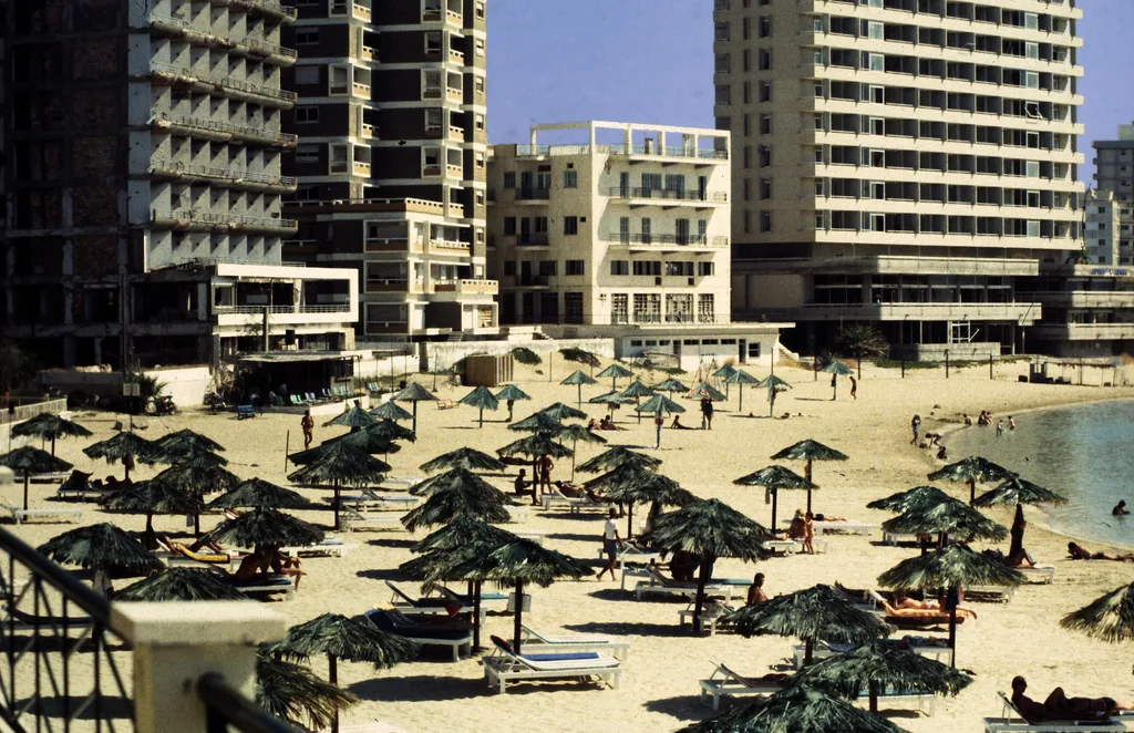 Palm Beach - a busy beach with parasols but there are abandoned hotels around it.
