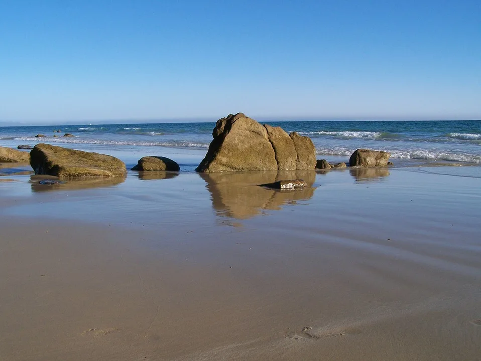 A tranquil beach framed by rocky outcrops in Barbate