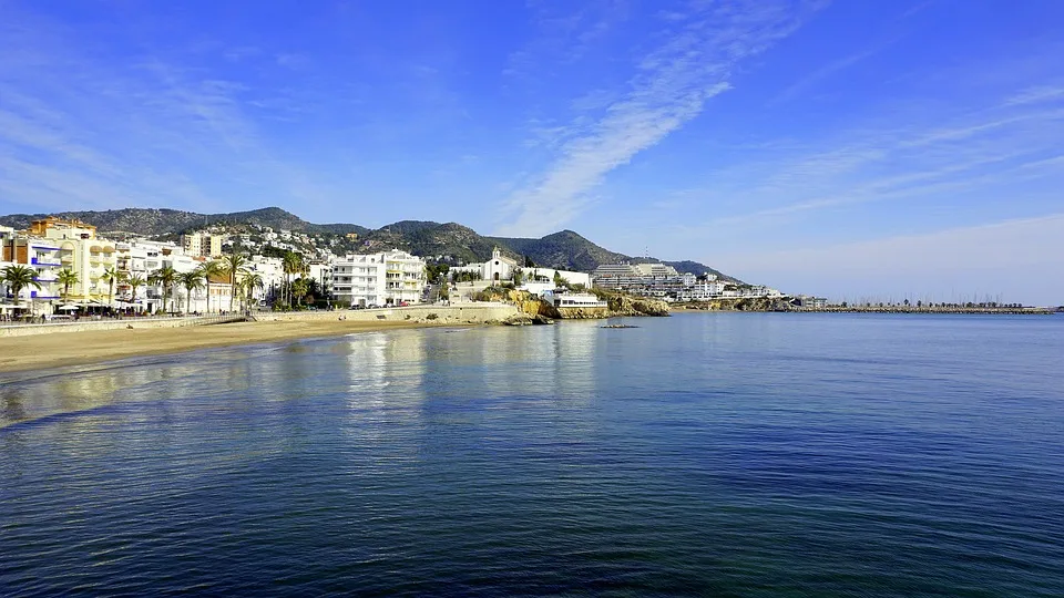 A curved bay with a small church in Sitges