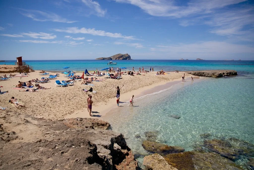 Basking in the white sand of Cala Comte beach