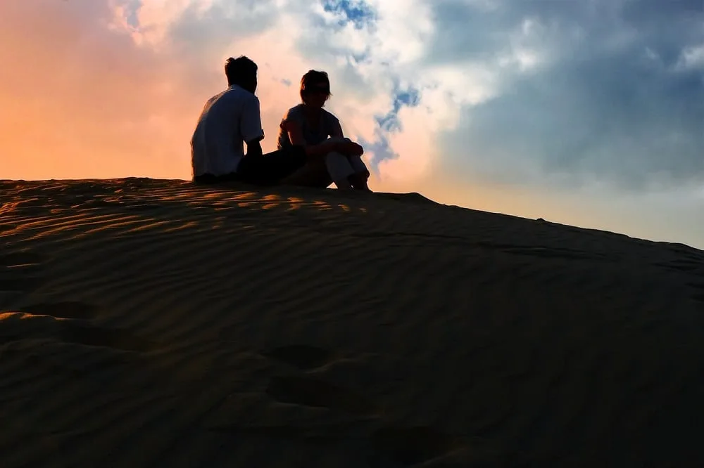Romantic couple watching sunset, Jaisalmer Desert