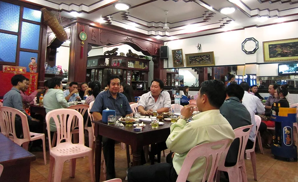 locals enjoying happy hour in a lao restaurant