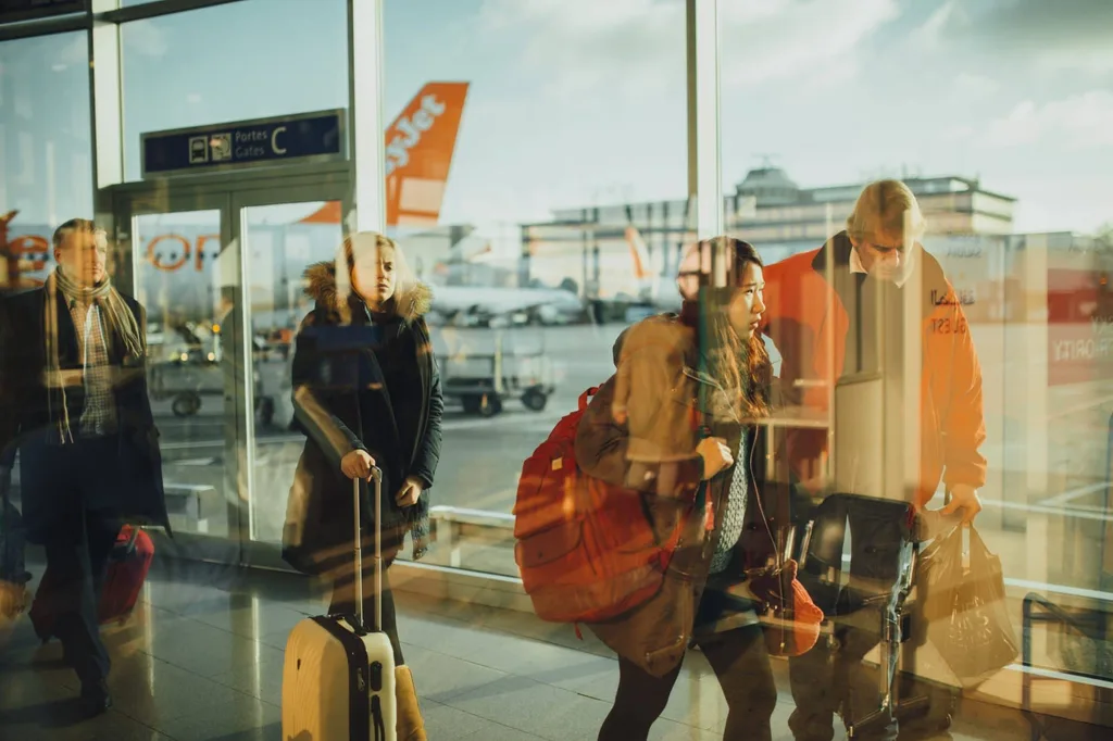 Passengers walking with baggage at the airport