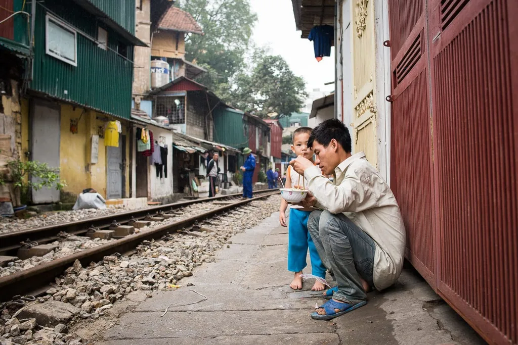 People eat near the railway