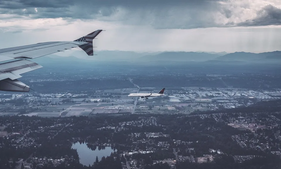 Aeroplanes Flying Low over a City Below