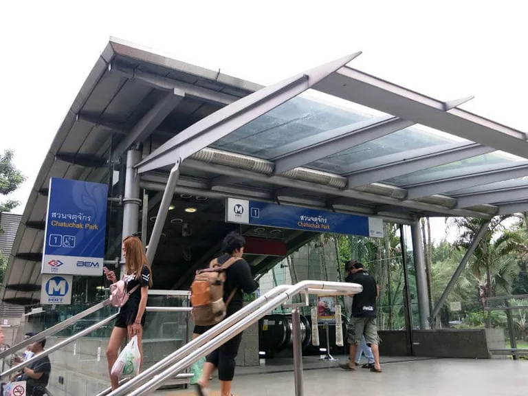 people walking into the mrt station