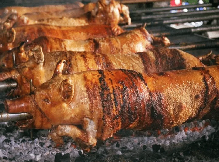Cooking Lechon over charcoal