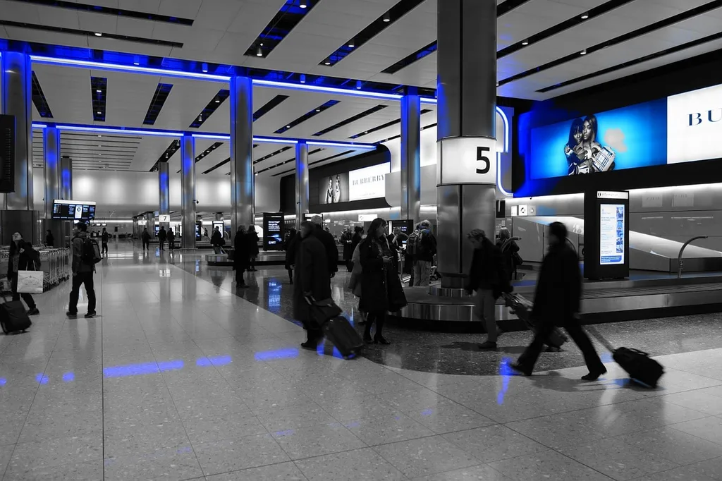 Airport terminal with people and suitcases